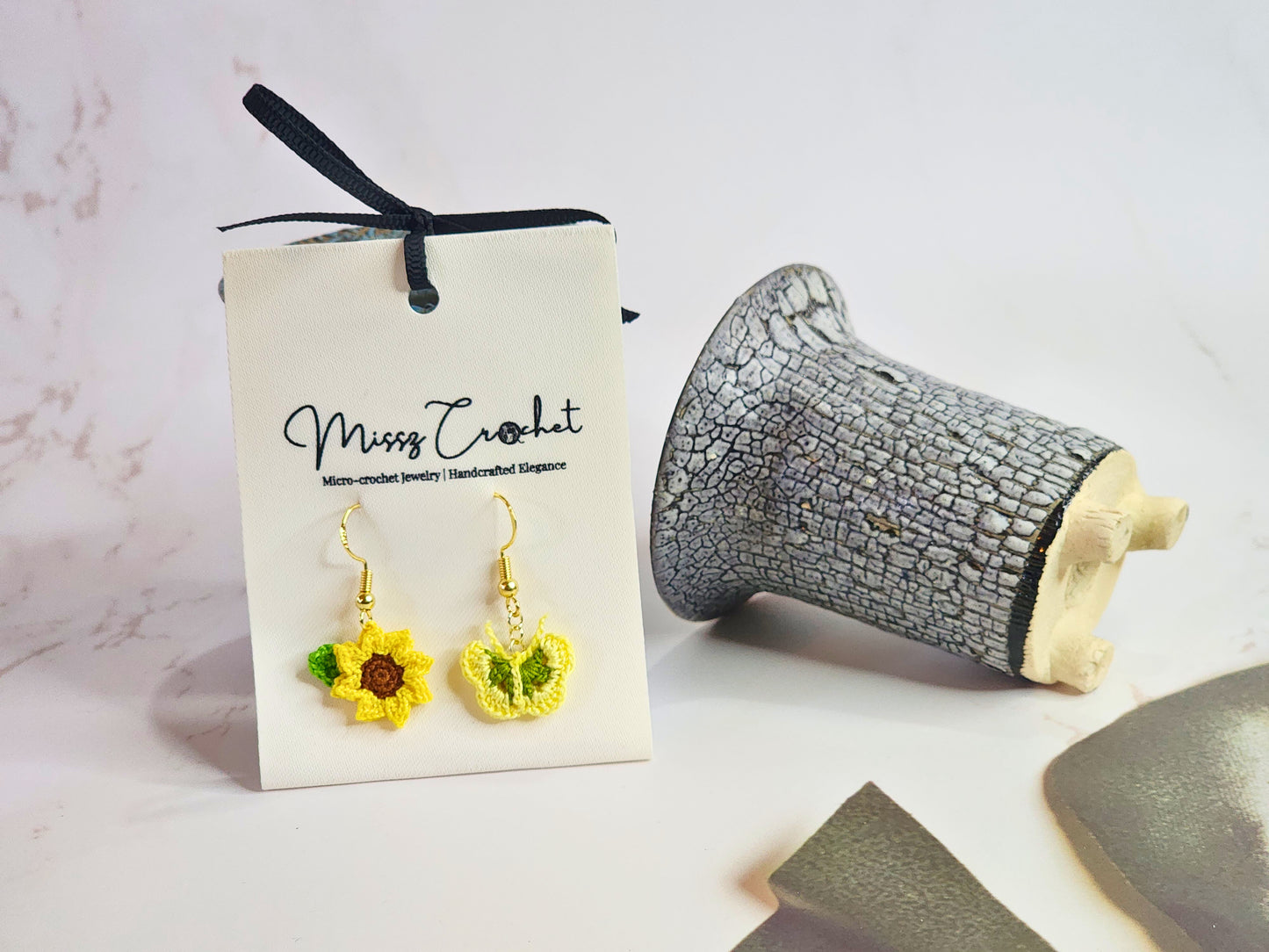 Handcrafted micro‑crochet Sunflower & Butterfly dangling earrings. Set on 18K gold-plated hooks.