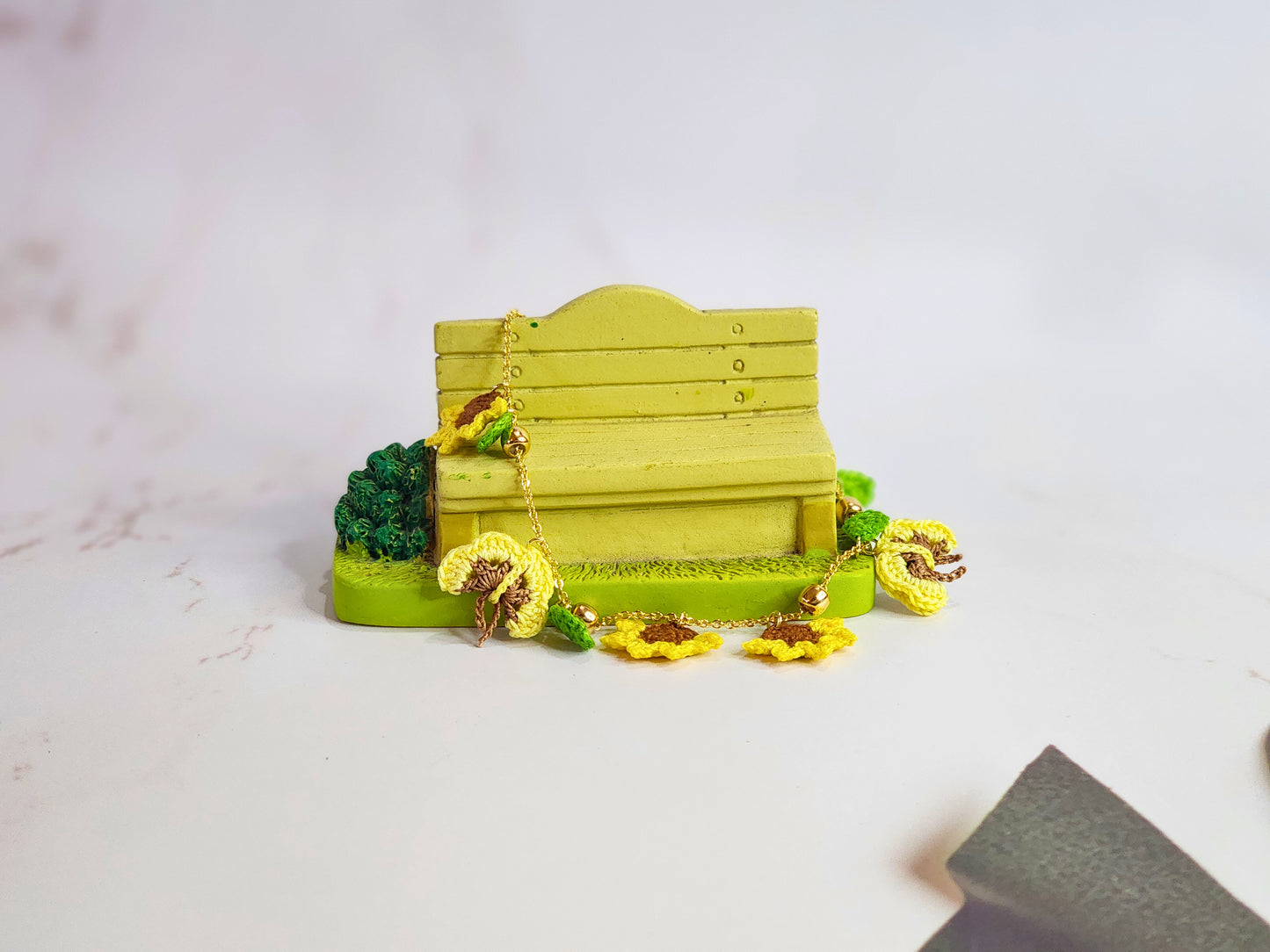 Handcrafted micro-crochet sunflowers & butterflies bracelet. 18K gold-plated adjustable chain.