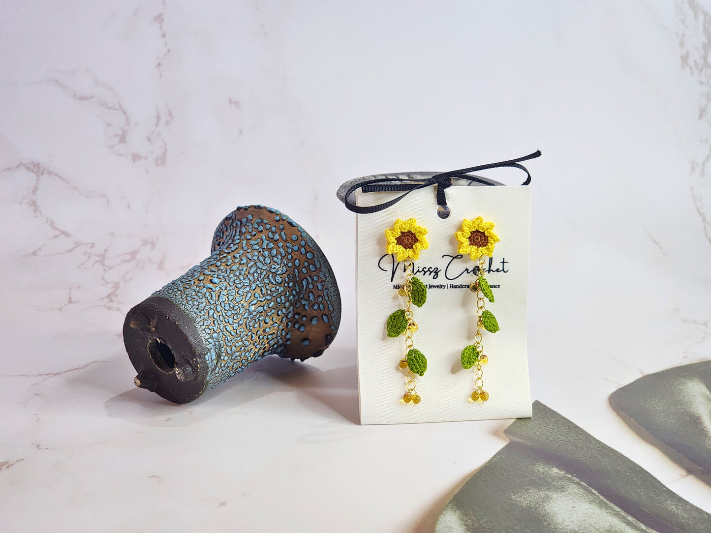 Handcrafted micro-crochet sunflowers and leaves earrings with a cascade of Miyuki waterdrop glass beads from Japan. 18K gold-plated studs.