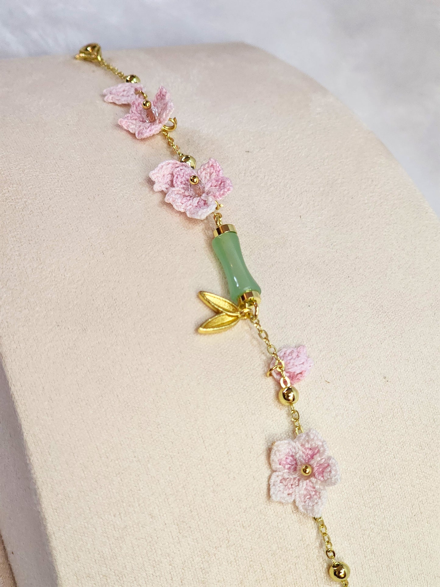 Natural Hetian Jade bracelet with handcrafted pink micro-crochet peach blossoms on 916 gold bracelet