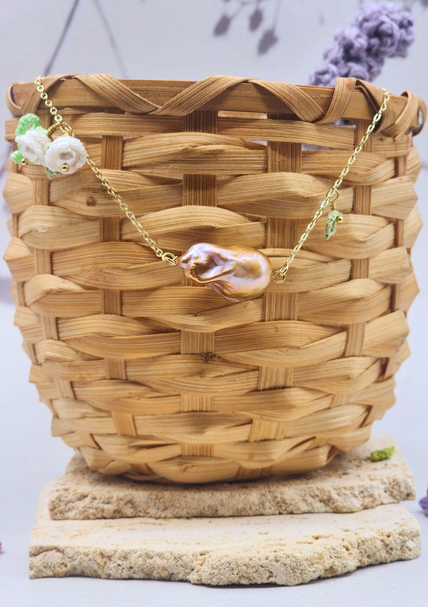 Suspended beneath two handcrafted micro crochet Lily of the Valley blooms is a captivating metallic purple-gold Baroque pearl. Each bloom is crowned with luminous 6mm Aurora pearls. On 18K gold-plated necklace chain.