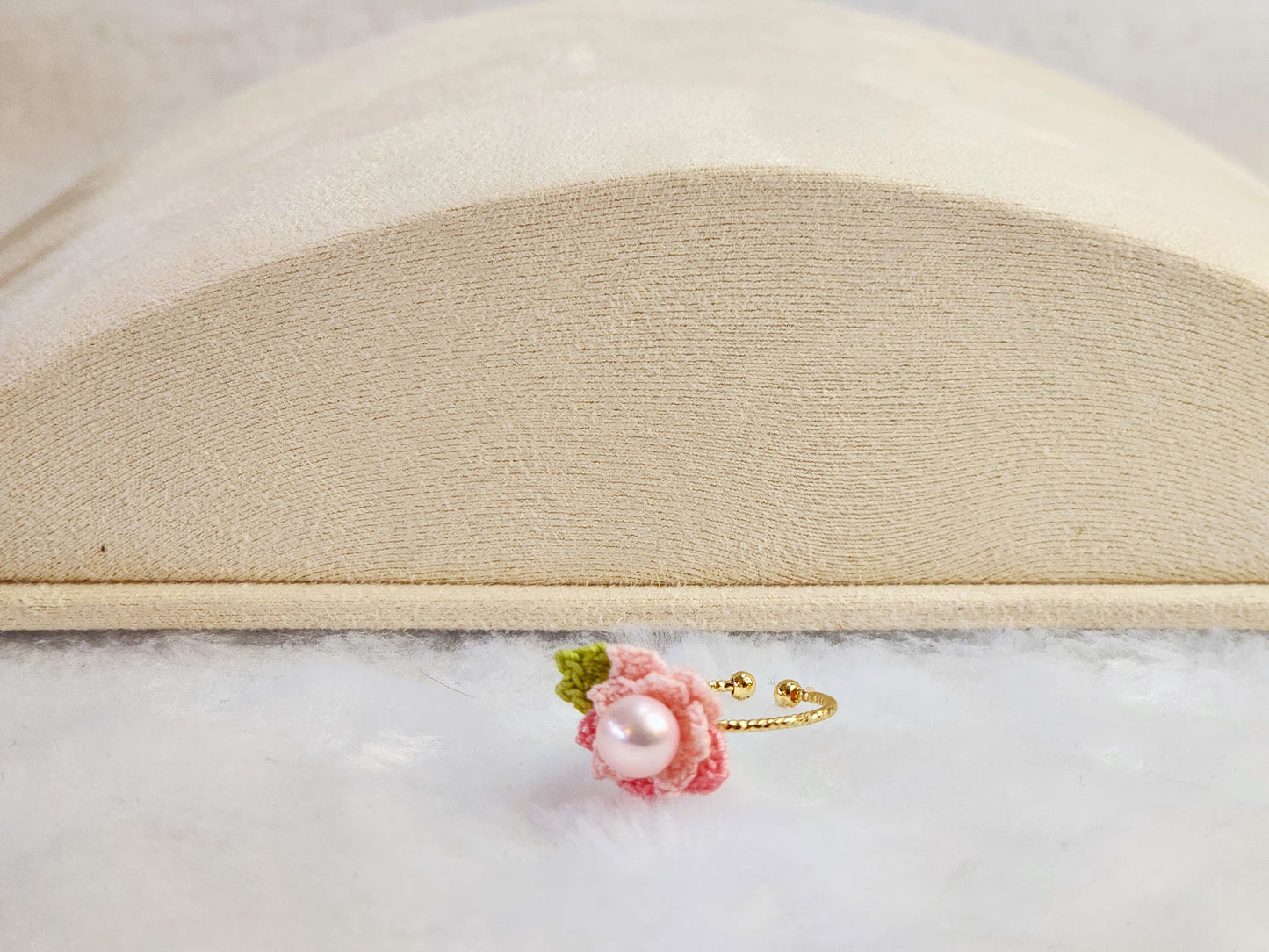 Lustrous pearl ring with pink handcrafted micro-crochet peach blossoms. 14K gold-plated adjustable ring.