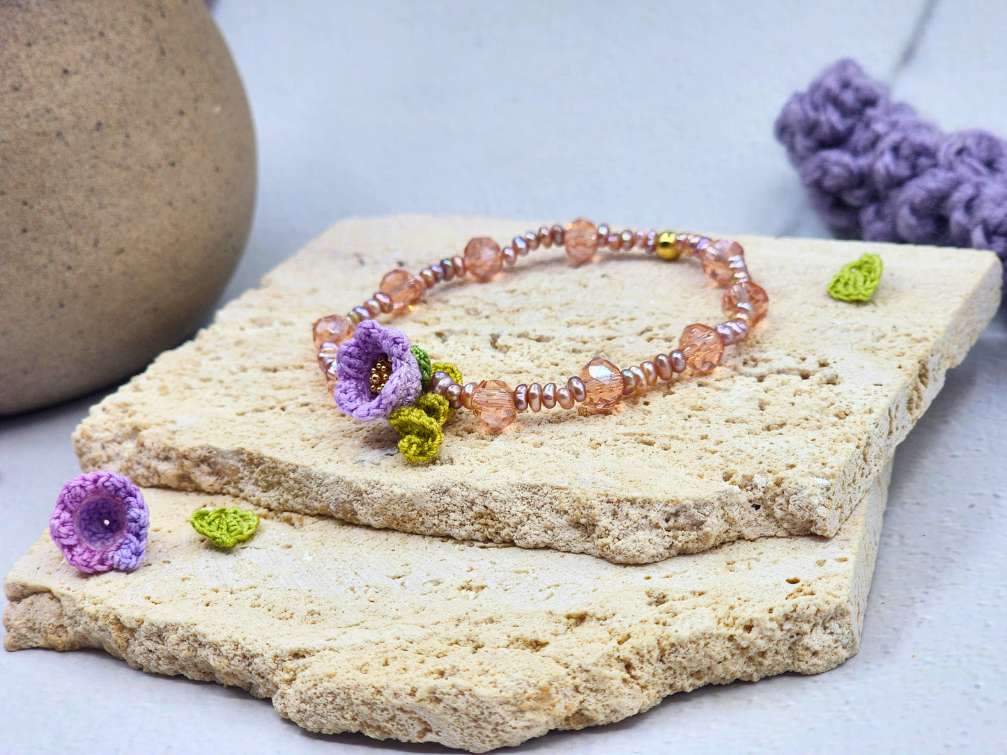 Handcrafted micro crochet Lily of the Valley bloom bracelet beautifully complemented by radiant 3–4mm metallic baroque pearls and sparkling Czech crystals.