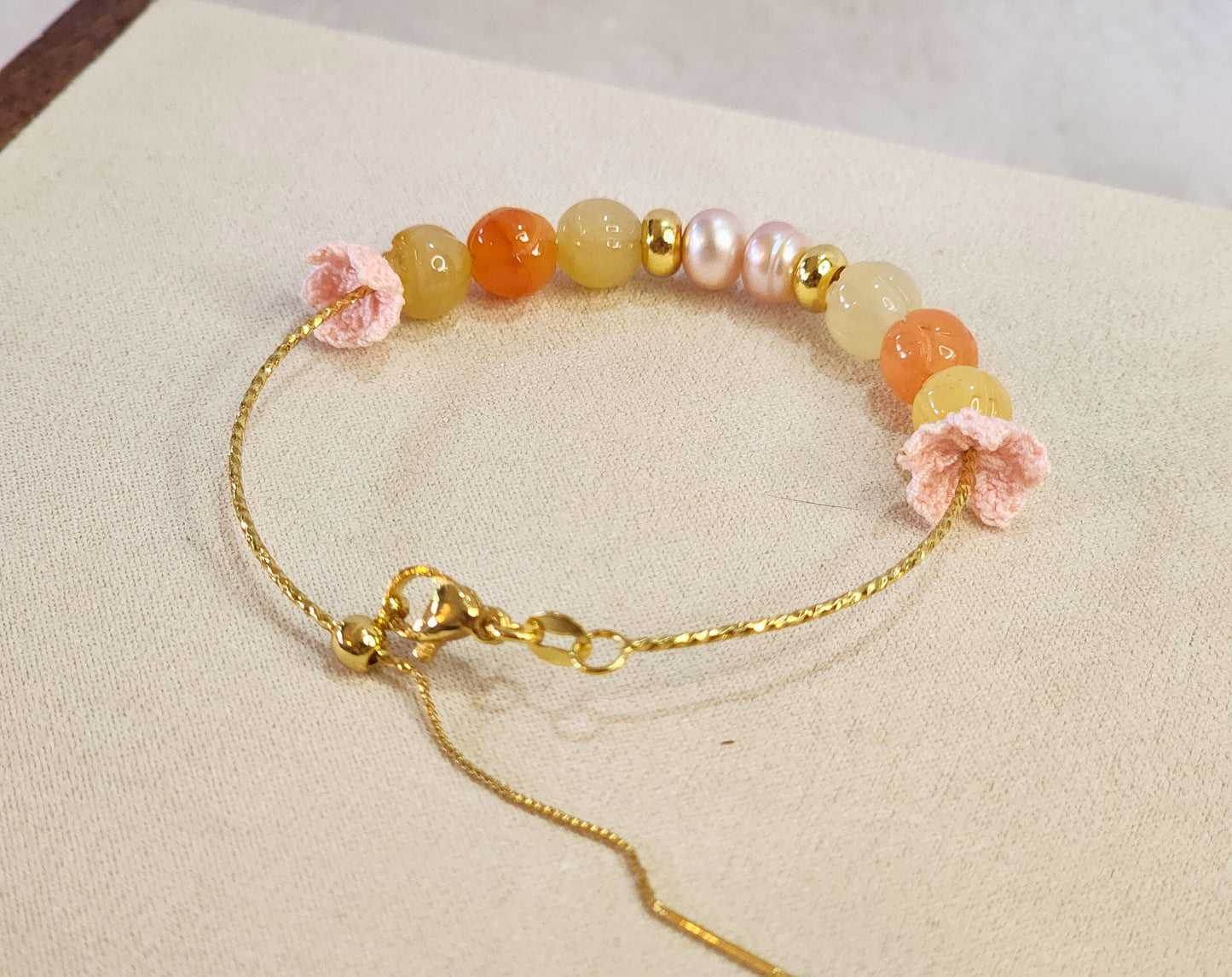 Natural quartz crystals and pearls bracelet with pink handcrafted micro-crochet peach blossoms on 18K gold-plated bracelet.