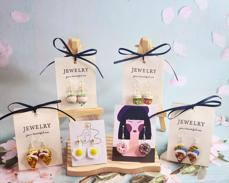 Collection of amigurumi micro-crochet jewelry including Sakura mochi and bubble tea to watermelon and fried eggs. 18K gold-plated.