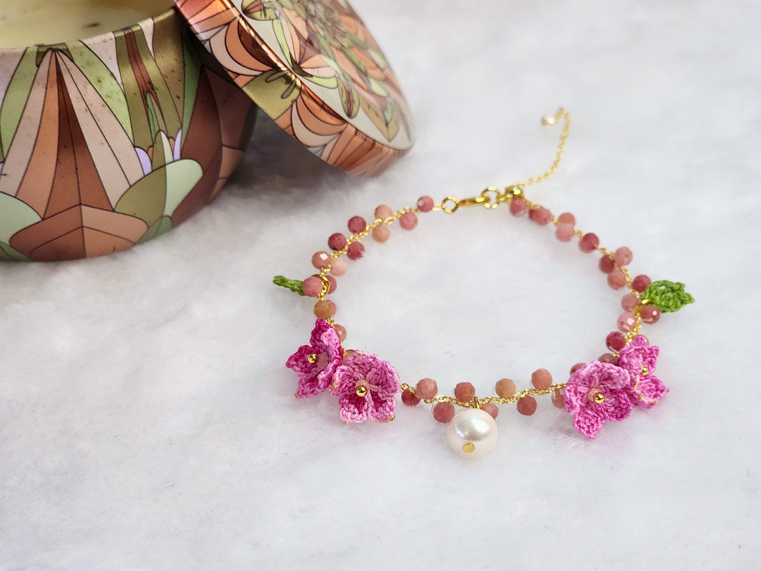 Rhodochrosite crystal & pearl bracelet with handcrafted micro-crochet peach blossoms for prosperity & luck. 14K gold-plated bracelet.
