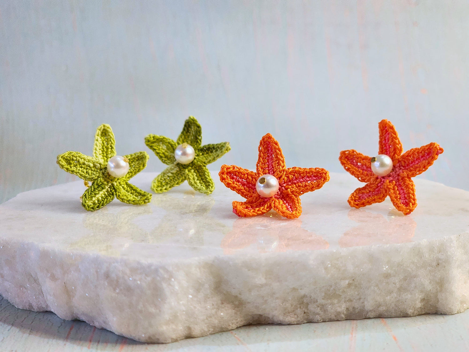 Handcrafted micro-crochet seashell rings with lustrous pearls on gold-plated adjustable rings