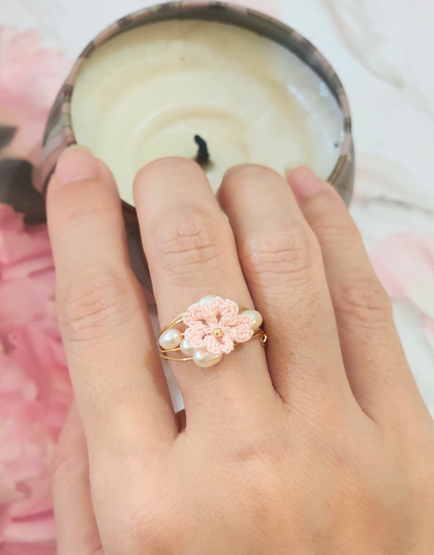 Natural 4-5mm Baroque pearls flank a handcrafted micro-crochet pink Sakura, on an 18K gold-plated ring.