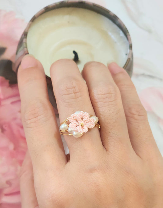 Natural 4-5mm Baroque pearls flank a handcrafted micro-crochet pink Sakura, on an 18K gold-plated ring.