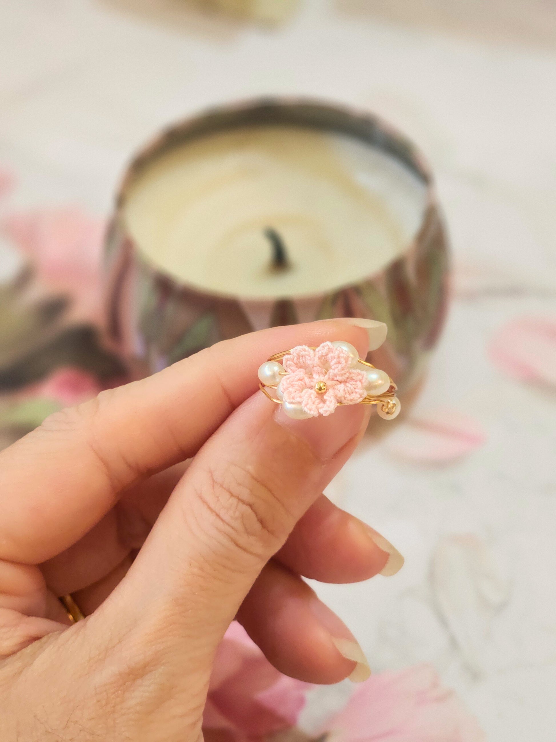 Natural 4-5mm Baroque pearls flank a handcrafted micro-crochet pink Sakura, on an 18K gold-plated ring.