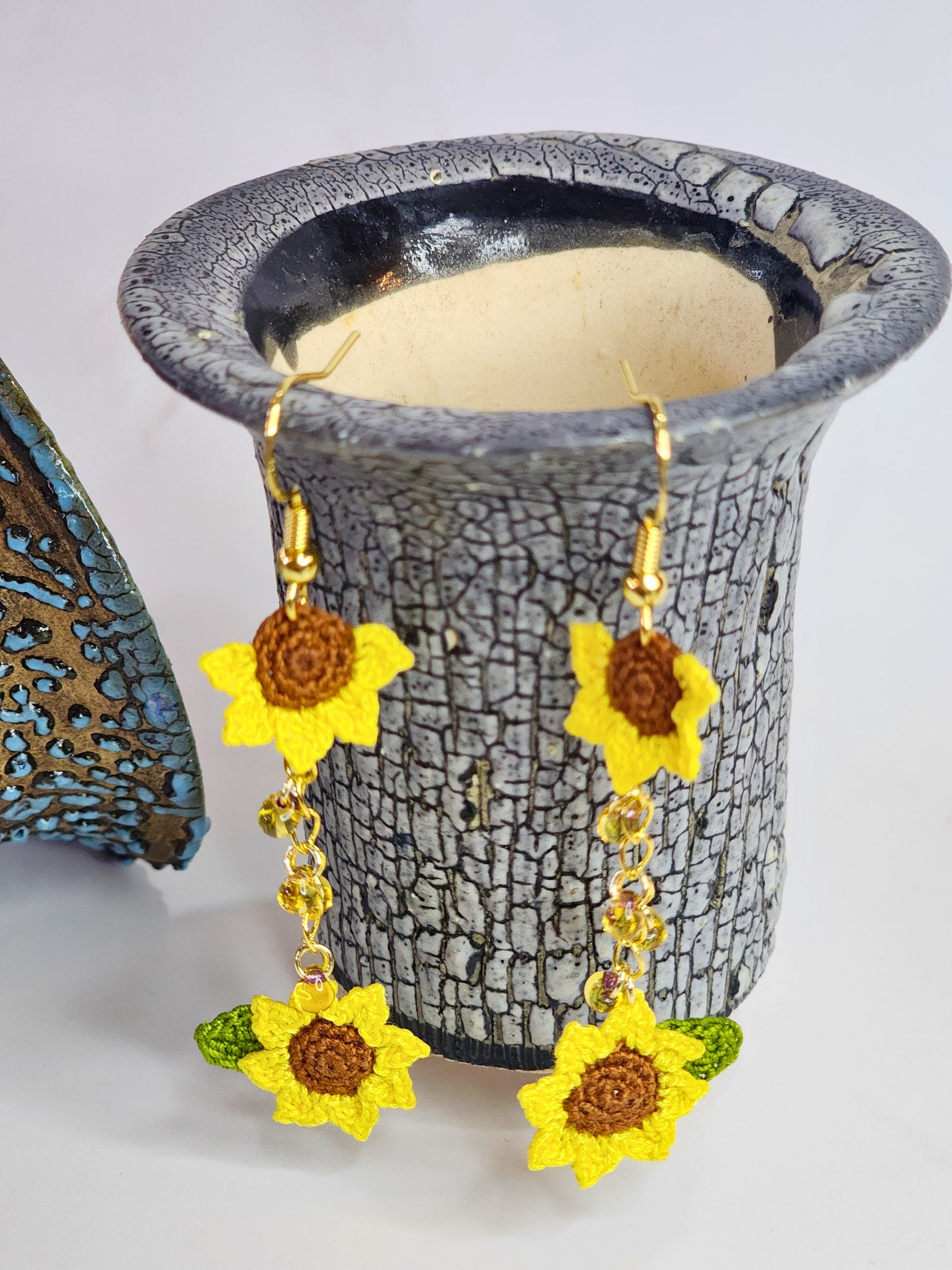 Handcrafted micro-crochet duo sunflowers adorned with a cascade of Miyuki waterdrop glass beads. 18K gold-plated hooks. 