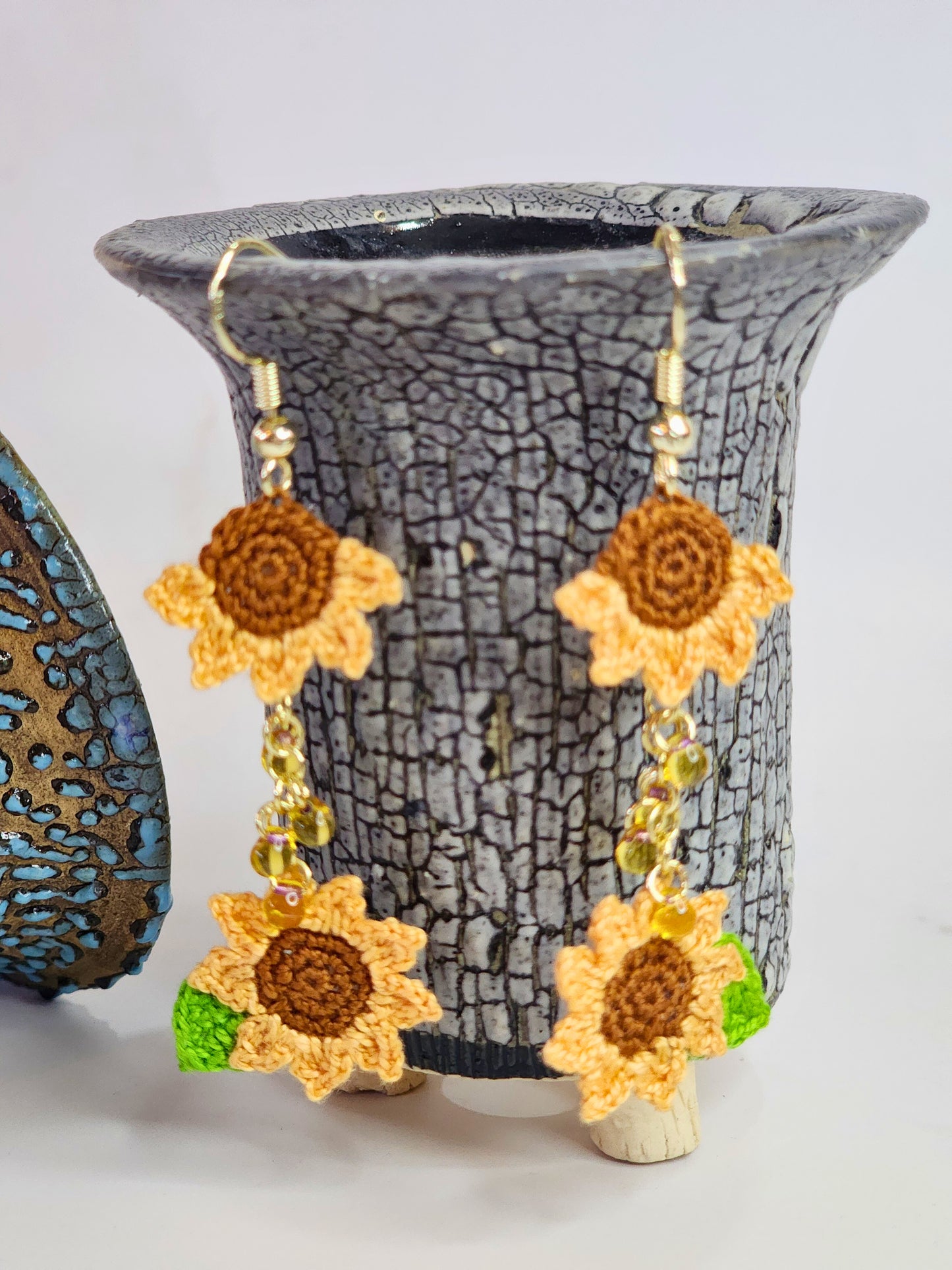 Handcrafted micro-crochet orange sunflowers duo with cascade of Miyuki waterdrop glass beads. 14K gold-plated ear hooks.
