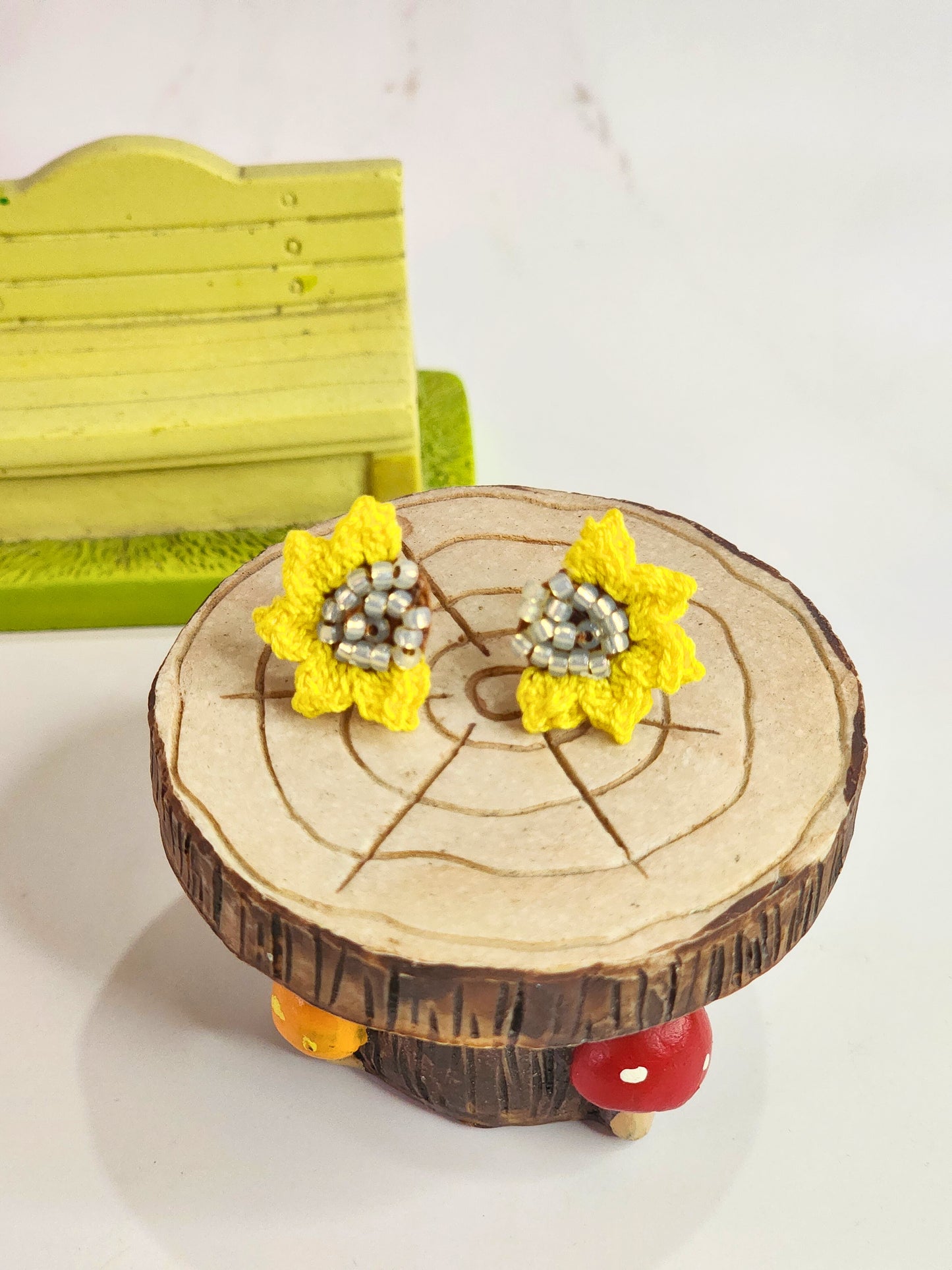 Handcrafted micro-crochet half sunflower with Czech glass beads at its heart. 18K gold-plated studs. 