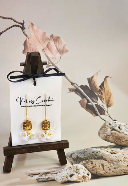 Handcrafted micro-crochet daisies accented with gleaming gold & vintage Czech glass beads. Styled with 18K gold-plated tassel hooks