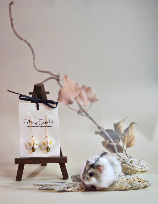 Handcrafted micro-crochet daisies earrings accented with freshwater pearls & vintage glass beads. Styled with 18K gold-plated findings & tassel hooks. 