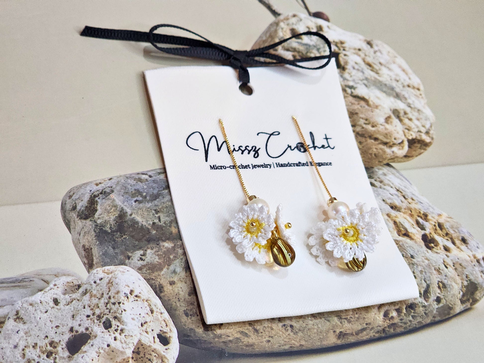 Handcrafted micro-crochet daisies earrings accented with freshwater pearls & vintage glass beads. Styled with 18K gold-plated findings & tassel hooks. 
