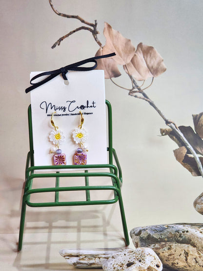 Handcrafted micro-crochet daisies earrings accented with freshwater pearls & vintage Czech glass beads. Styled with 18K gold-plated findings & hooks. 