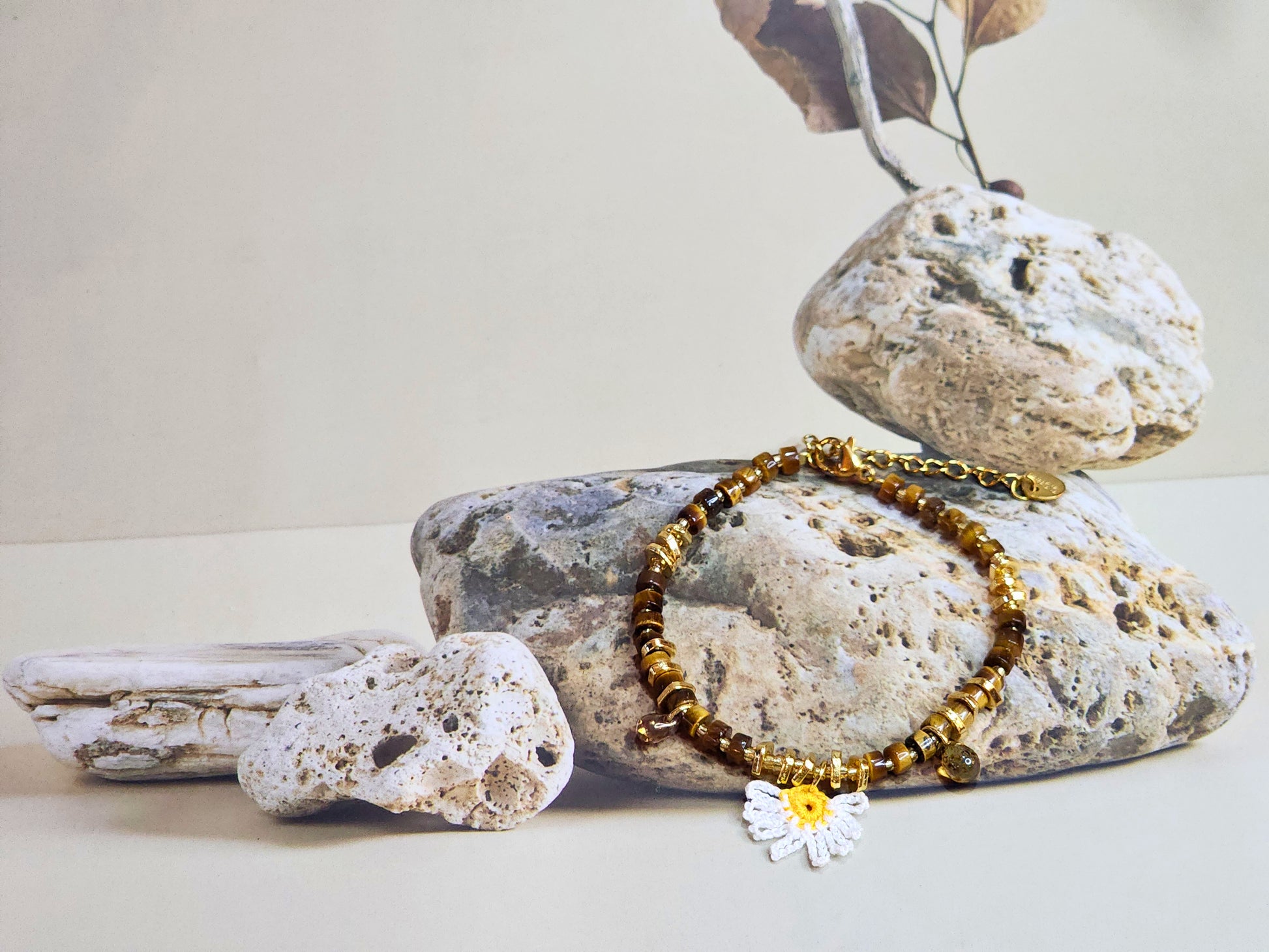 Natural Tiger Eye beaded bracelet with micro-crochet daisy. Paired with gold-plated spacer beads and vintage Czech glass beads. 18K gold-plated clasp. 