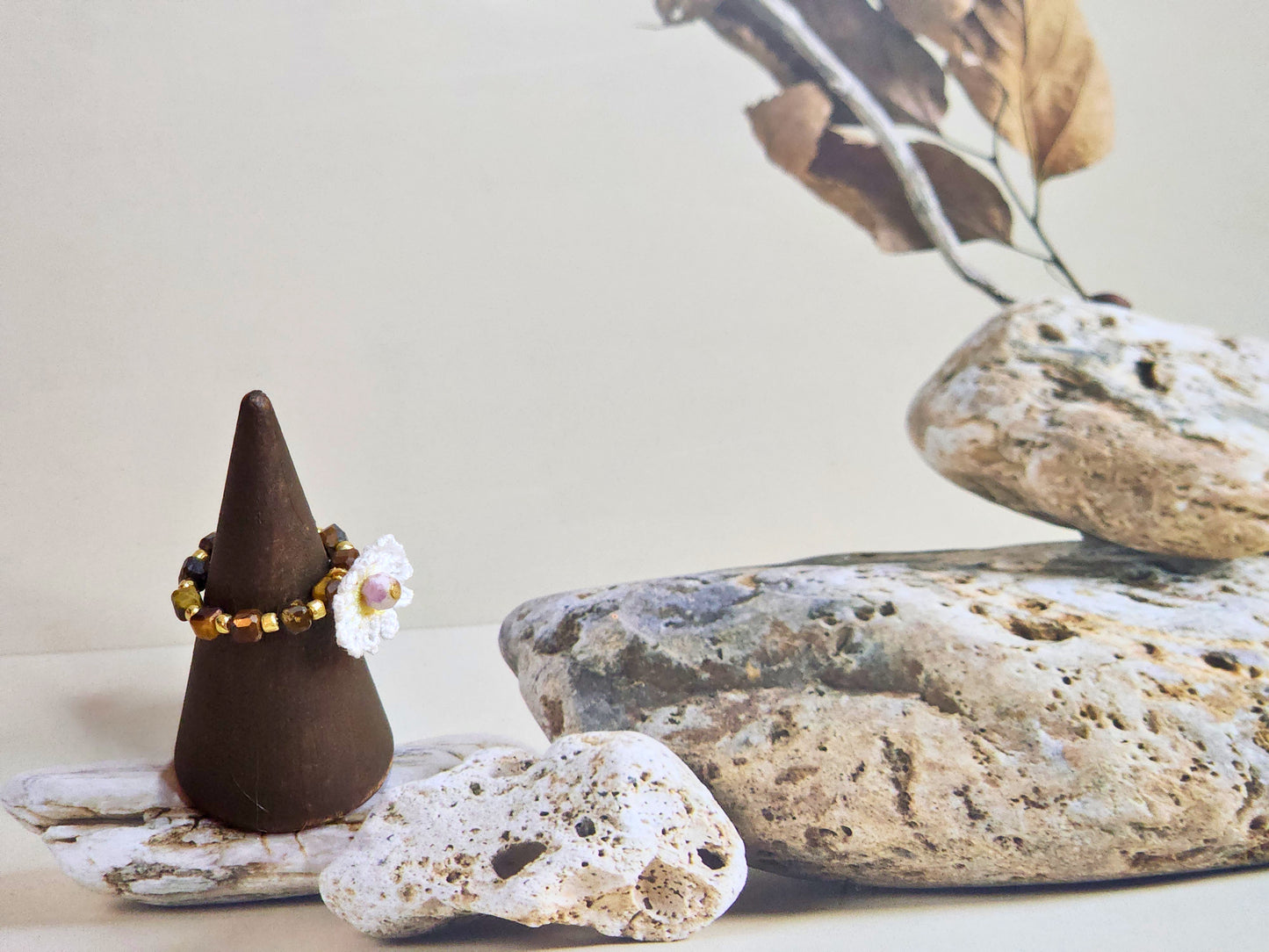 Tiger's Eye beaded ring with 18K gold-plated spacer beads. Accented with handcrafted micro-crochet daisy. 