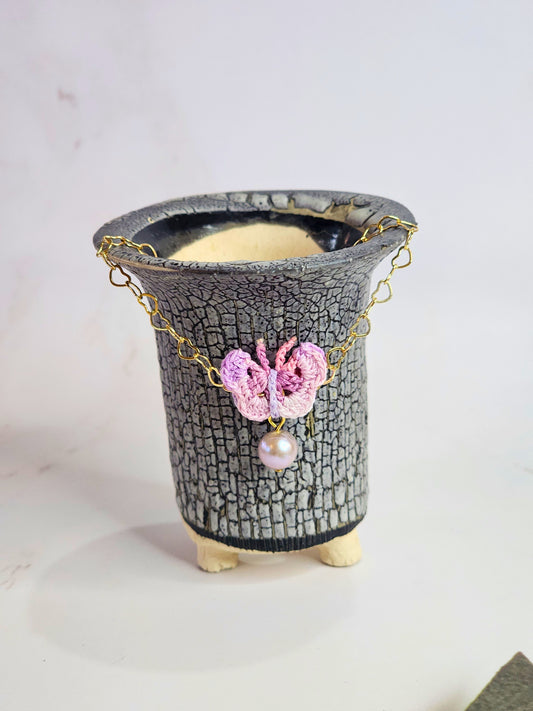 Handcrafted micro-crochet butterfly with 8mm purple freshwater pearl, set on 14K gold-filled heart-shaped bracelet.