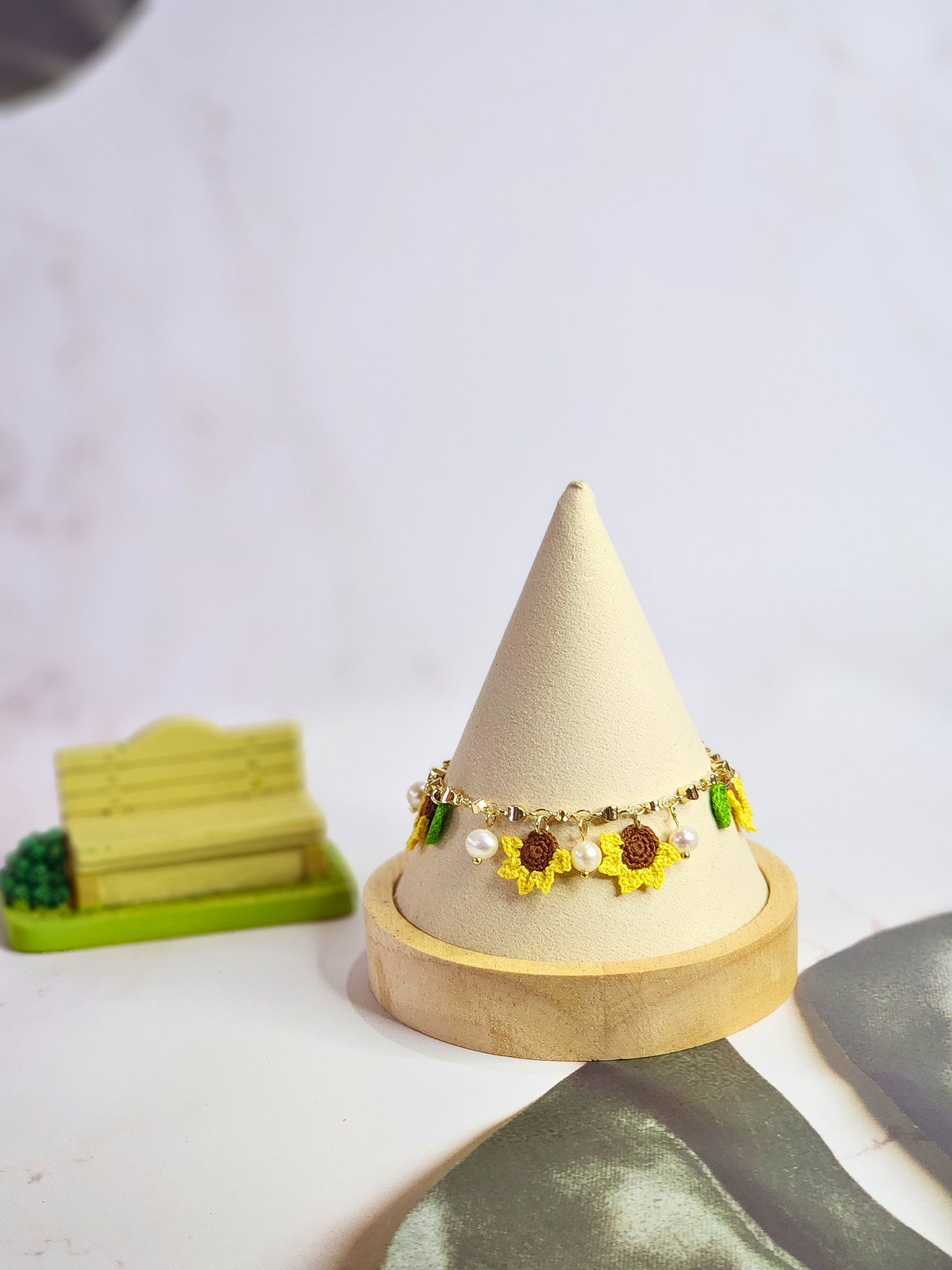 Handcrafted micro-crochet sunflowers & pearls bracelet. 6-7mm oval freshwater pearls set on 14K gold-plated adjustable chain.