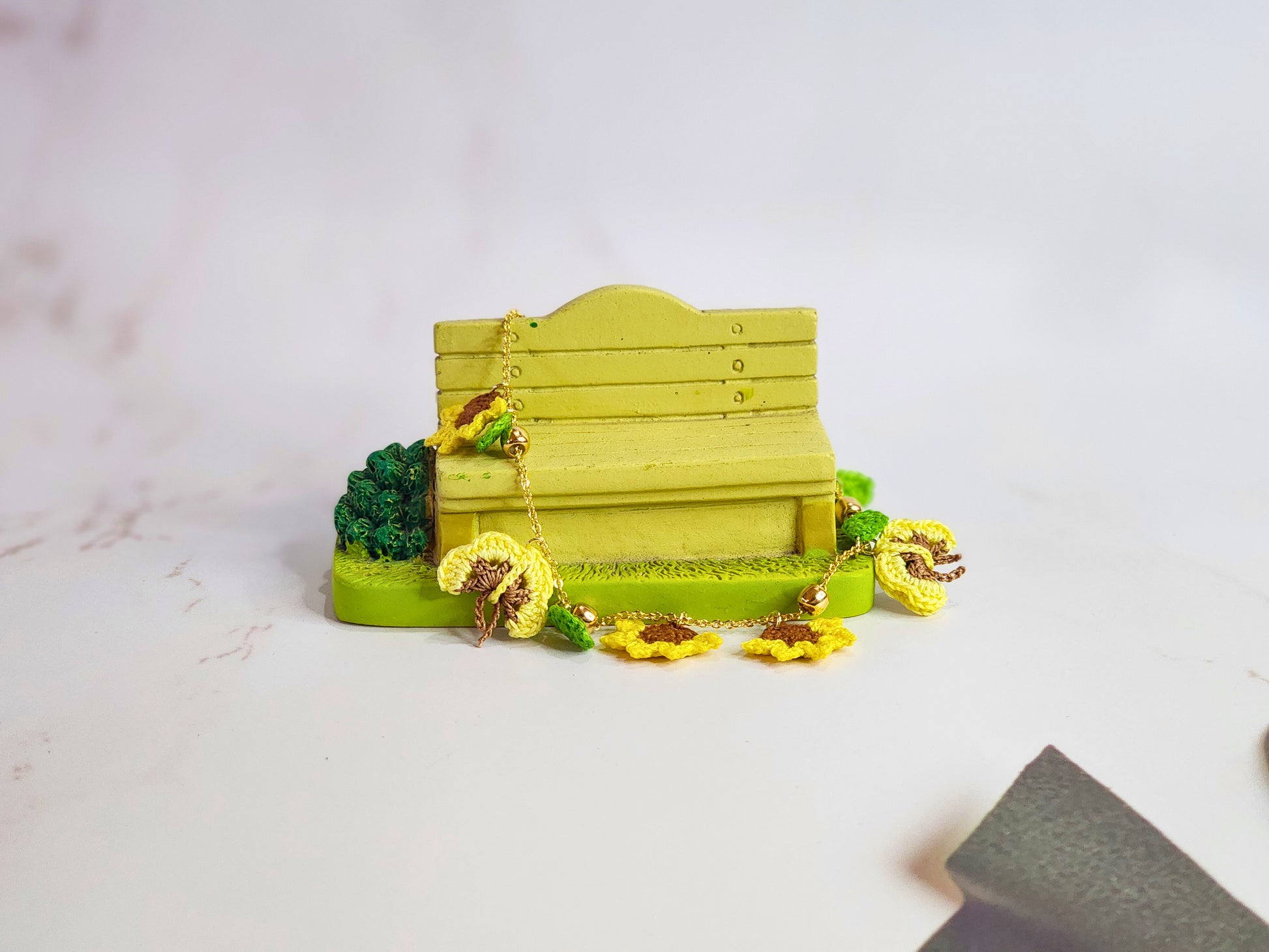 Handcrafted micro-crochet sunflowers & butterflies bracelet. 18K gold-plated adjustable chain.