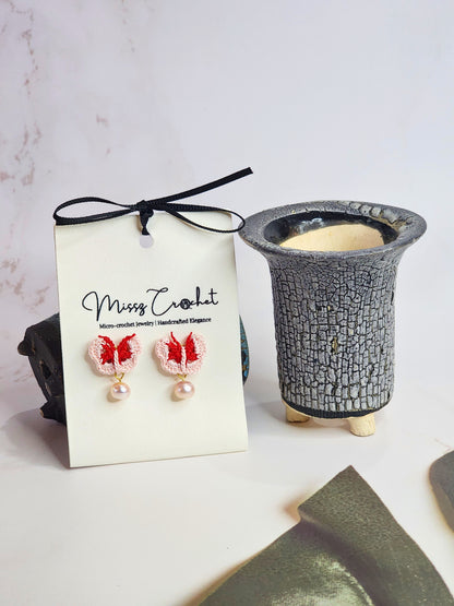 Handcrafted pink-red micro-crochet butterflies adorned with 6-7mm natural freshwater pearls. 18K gold-plated studs. 
