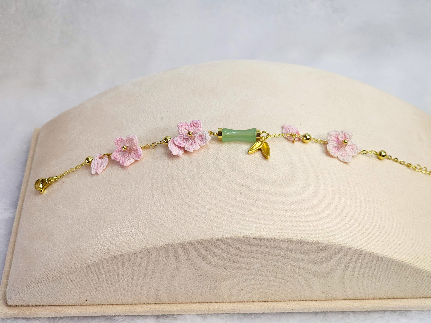 Natural Hetian Jade bracelet with handcrafted pink micro-crochet peach blossoms on 916 gold bracelet