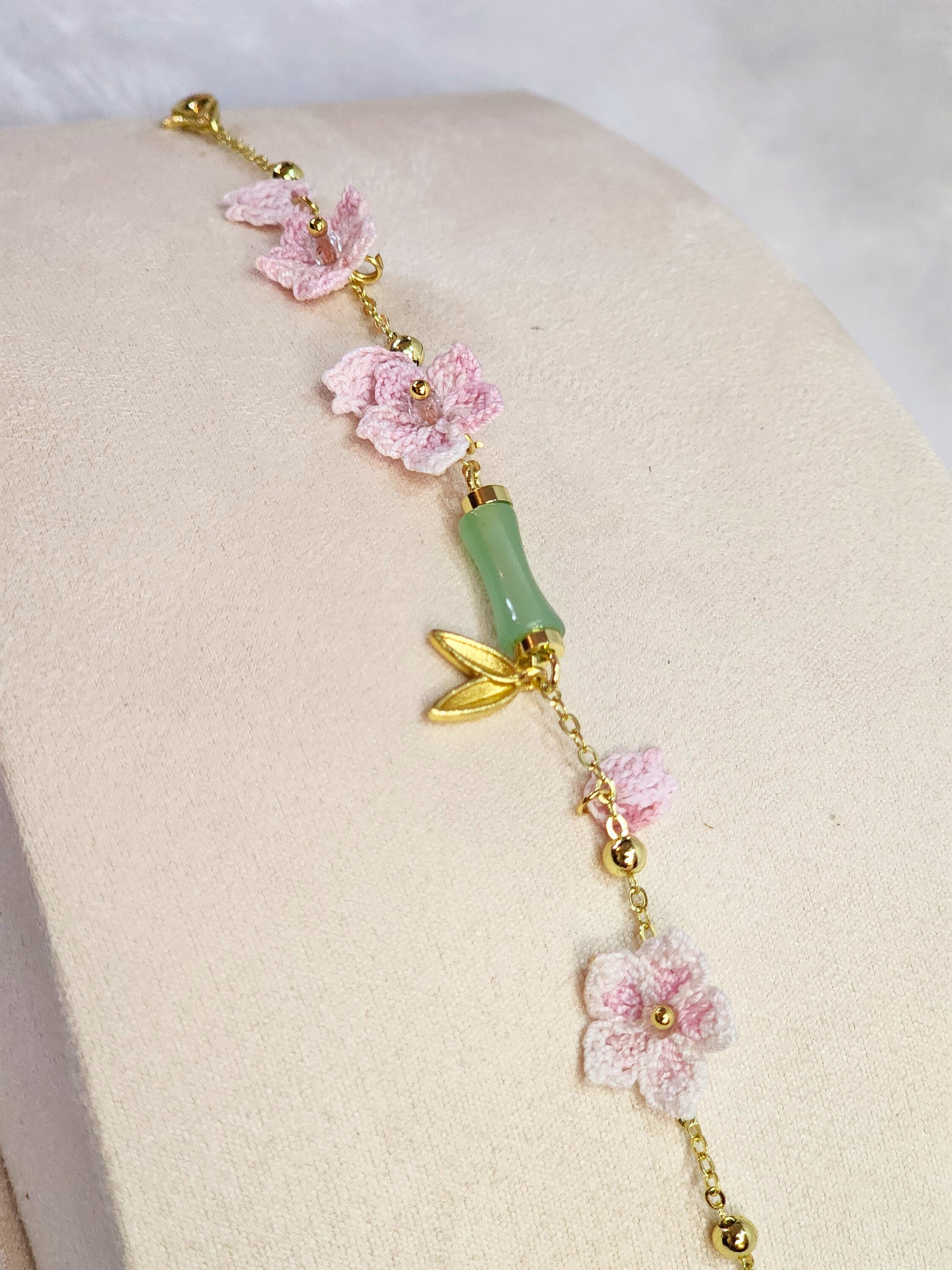 Natural Hetian Jade bracelet with handcrafted pink micro-crochet peach blossoms on 916 gold bracelet