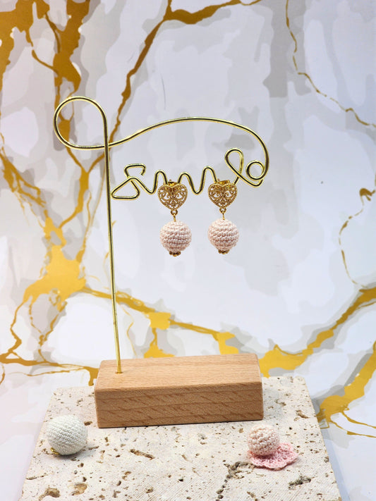 Handcrafted light pink crochet pearls inspired by the luminous beauty of Japanese seawater pearls. Styled with 18K gold-plated lace heart studs.