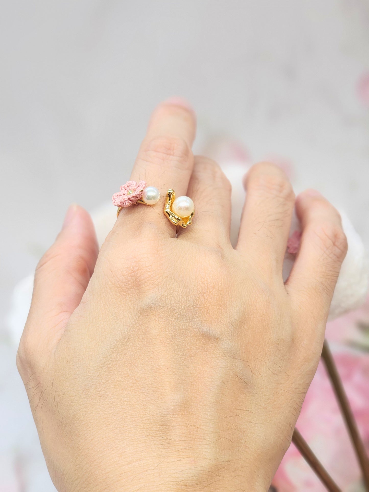 High lustre freshwater Akoya pearls ring. Accented with a singular pink micro crochet Sakura bloom. 18K gold-plated adjustable band. 