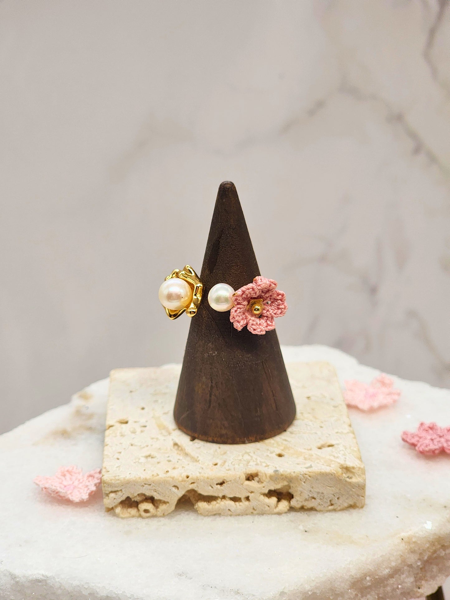 High lustre freshwater Akoya pearls ring. Accented with a singular pink micro crochet Sakura bloom. 18K gold-plated adjustable band. 