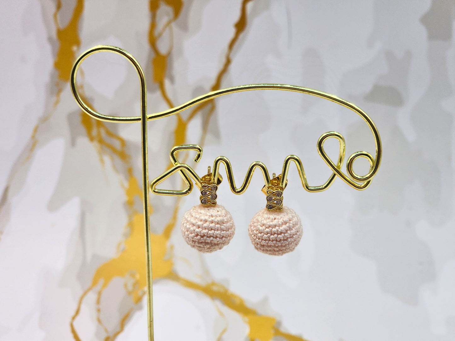 Handcrafted light pink crochet pearls inspired by the luminous beauty of Japanese seawater pearls. Styled with 18K gold-plated cubic zirconia studs.