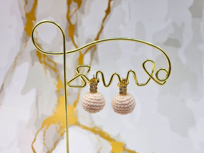 Handcrafted light pink crochet pearls inspired by the luminous beauty of Japanese seawater pearls. Styled with 18K gold-plated cubic zirconia studs.