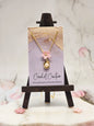 Handcrafted micro crochet Sakura with a lustrous 6–7mm Akoya pearl, suspended from a graceful pendant. Styled with 18K gold-plated pendant and chain. 