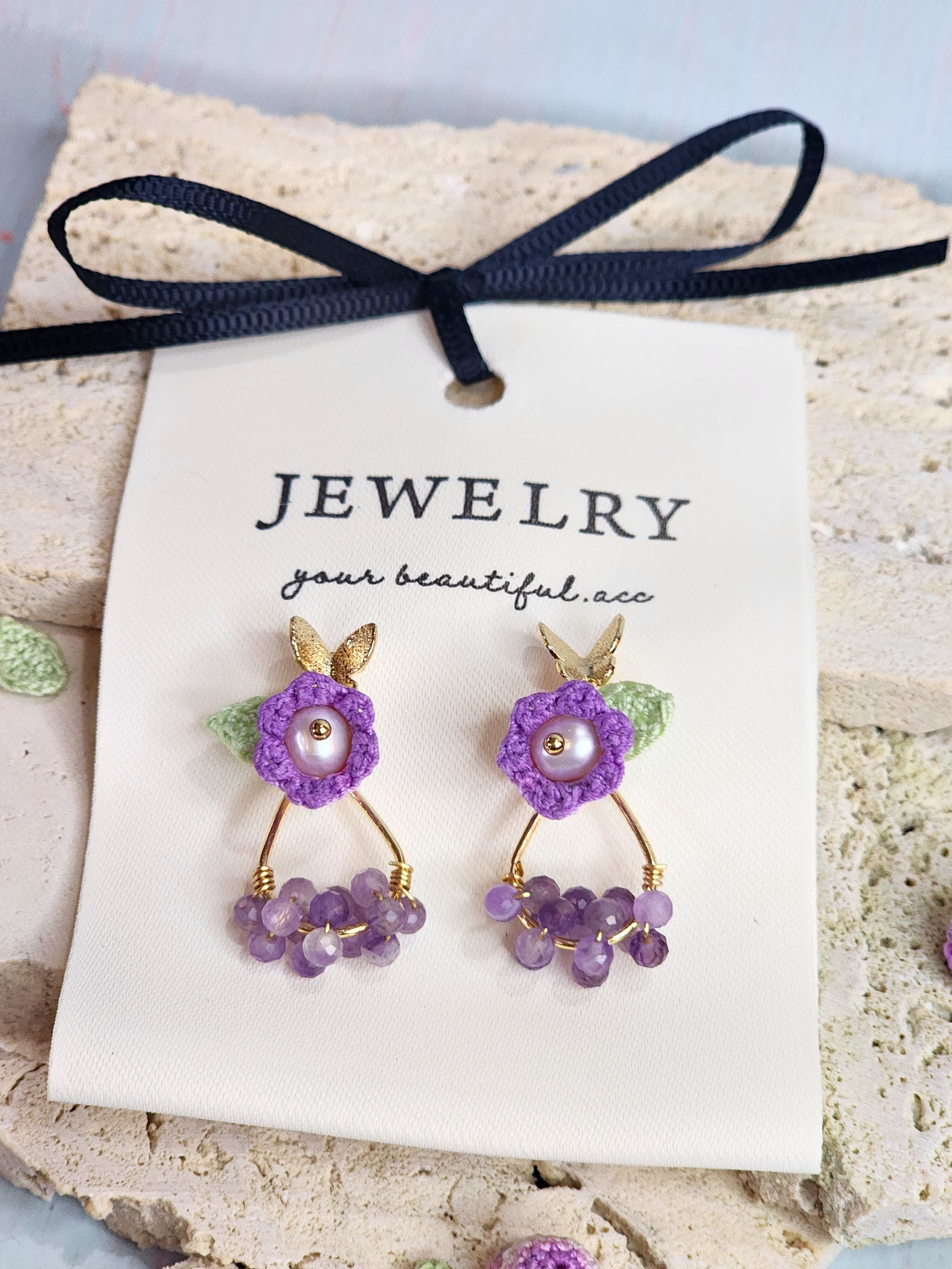Natural Amethyst earrings with handcrafted micro‑crochet Lily of the Valley adorned with natural 4.5-5mm smoke grey freshwater pearls close up