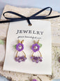 Natural Amethyst earrings with handcrafted micro‑crochet Lily of the Valley adorned with natural 4.5-5mm smoke grey freshwater pearls close up