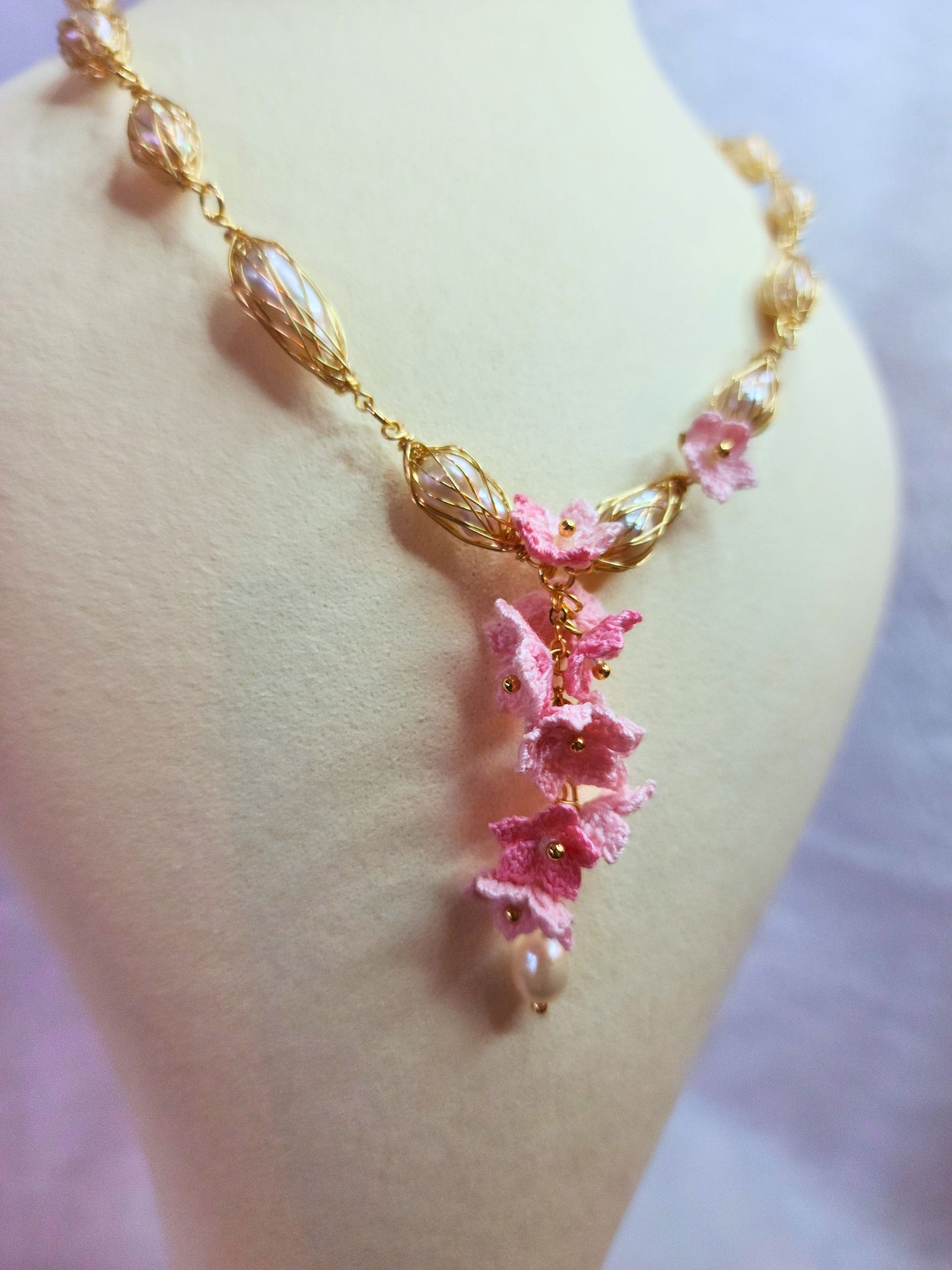 Baroque pearl gold twist necklace with a cascade of handcrafted pink micro-crochet peach blossoms.
