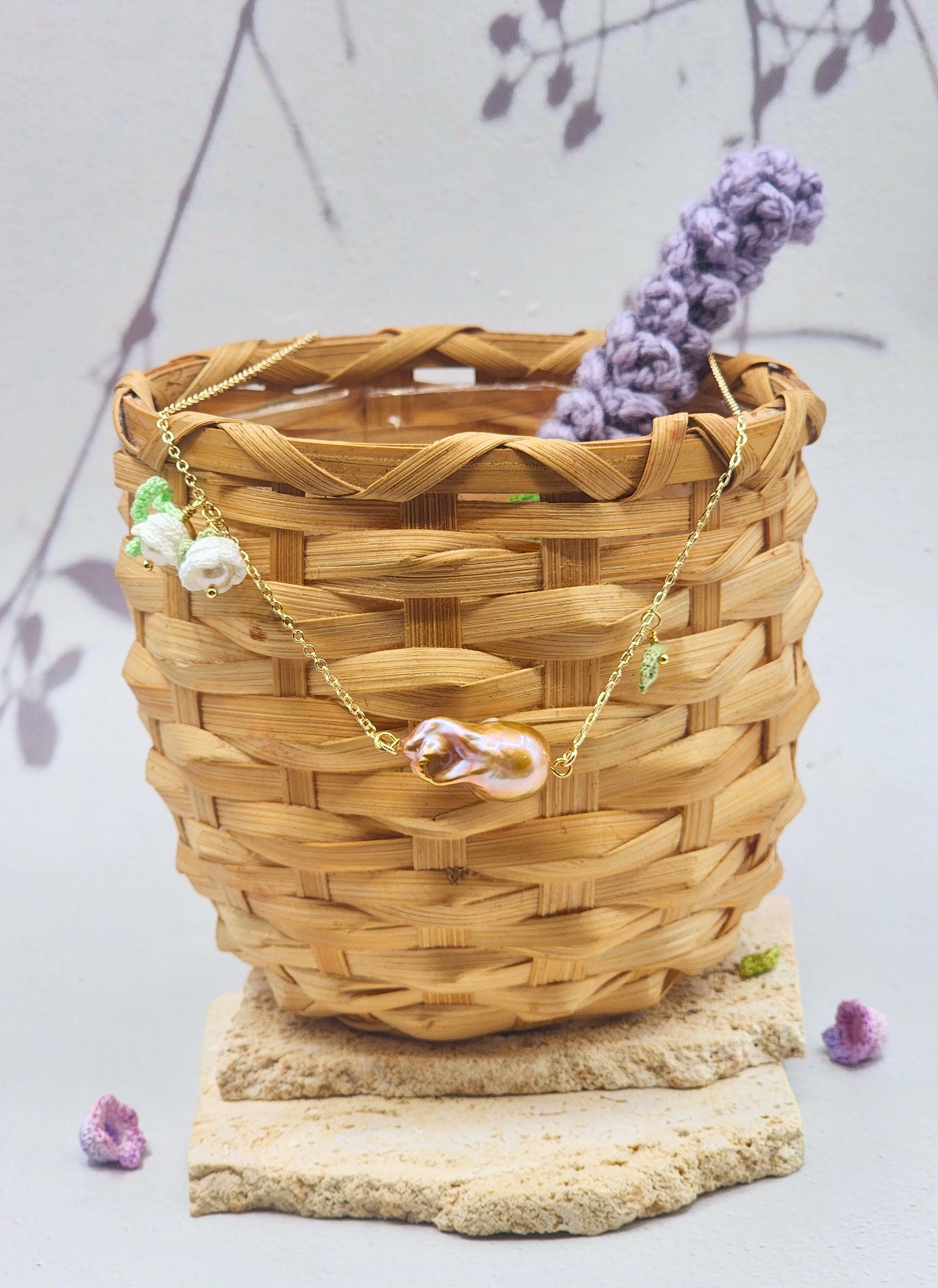 Suspended beneath two handcrafted micro crochet Lily of the Valley blooms is a captivating metallic purple-gold Baroque pearl. Each bloom is crowned with luminous 6mm Aurora pearls. On 18K gold-plated necklace chain. 