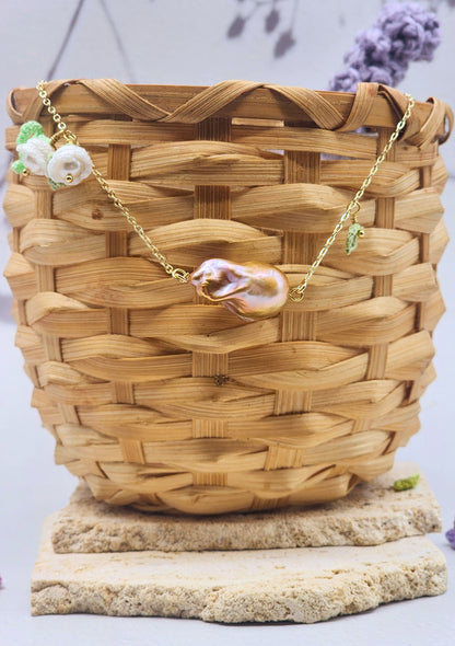 Suspended beneath two handcrafted micro crochet Lily of the Valley blooms is a captivating metallic purple-gold Baroque pearl. Each bloom is crowned with luminous 6mm Aurora pearls. On 18K gold-plated necklace chain. 