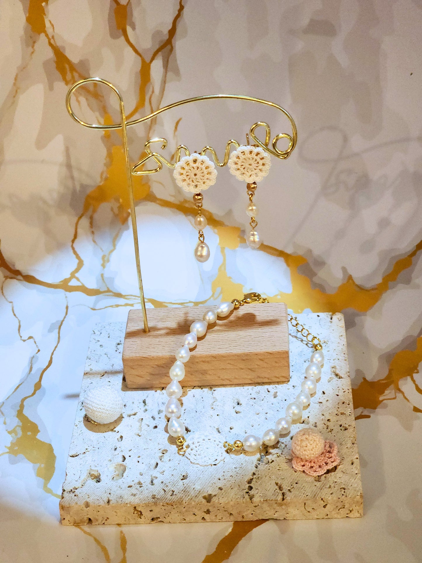 Handcrafted lace motif, beautifully framed by flawless 7–8mm teardrop-shaped pearls bracelet. Styled with 18K gold-plated bead accents and clasp.