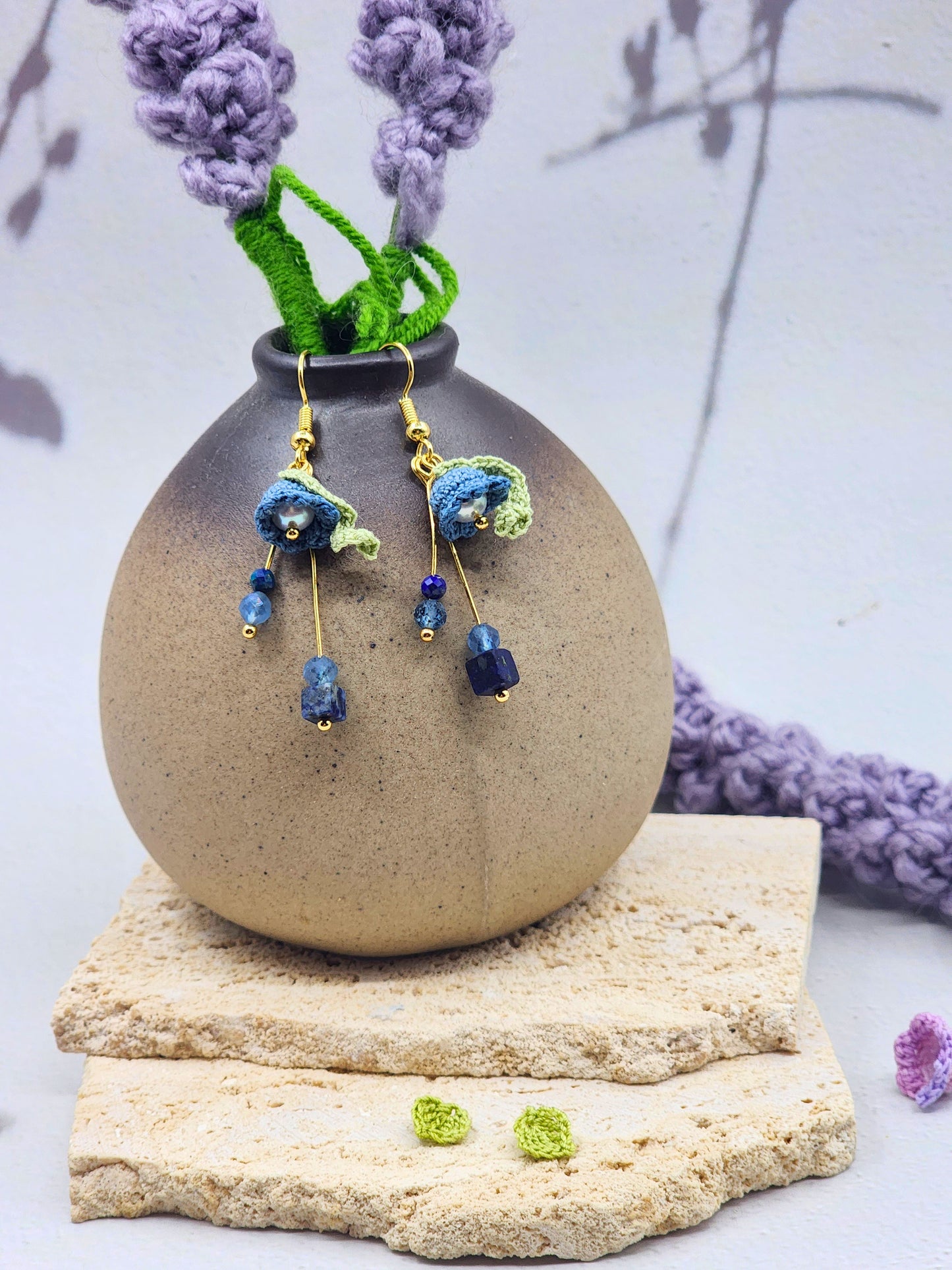 Handcrafted Lily of the Valley blooms are crowned with glowing 6mm freshwater Aurora pearls and accented with natural Lapis Lazuli and Aquamarine. 18K gold-plated.