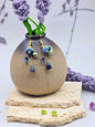 Handcrafted Lily of the Valley blooms are crowned with glowing 6mm freshwater Aurora pearls and accented with natural Lapis Lazuli and Aquamarine. 18K gold-plated.