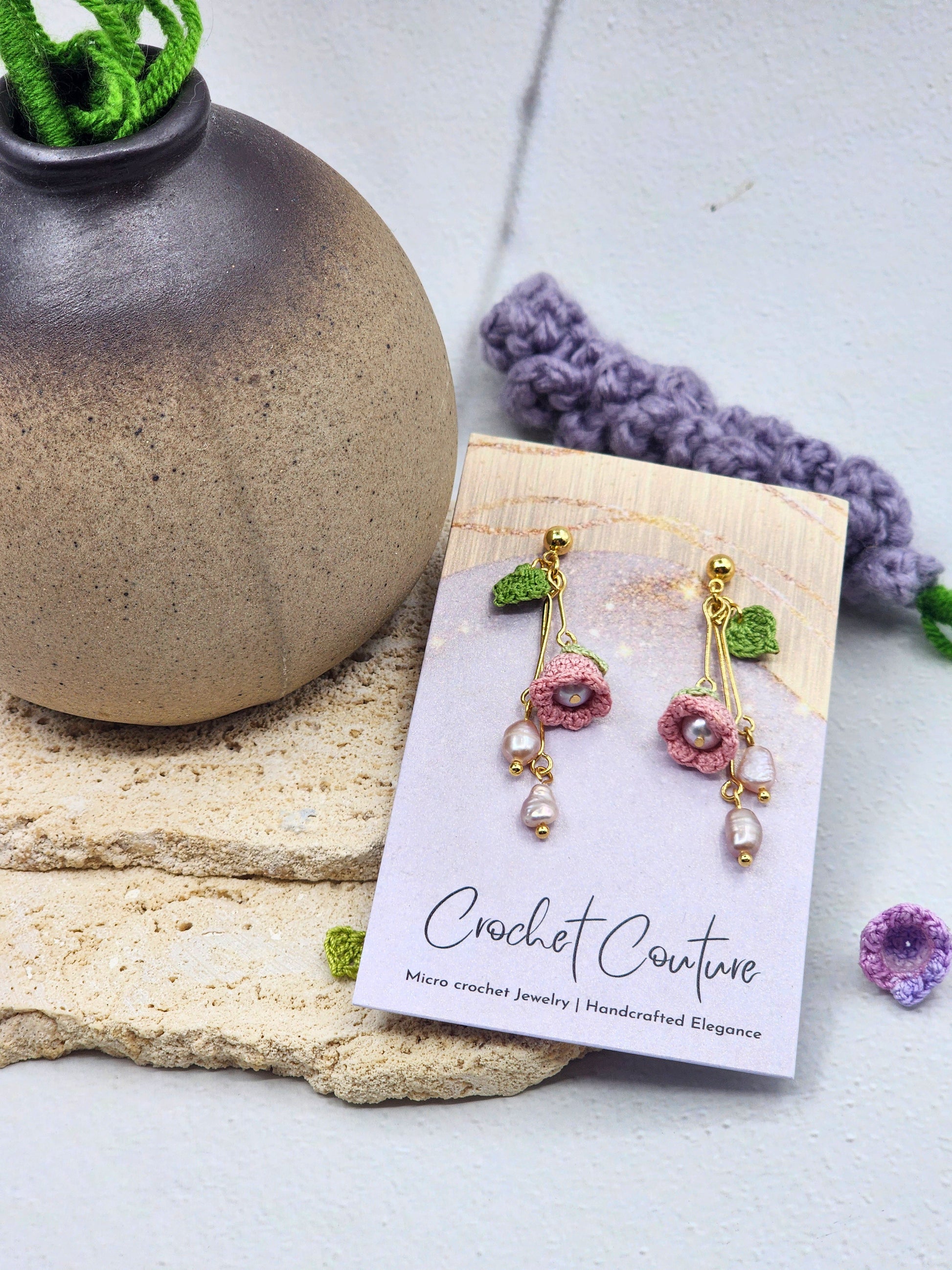 Handcrafted micro crochet Lily of the Valley blooms earrings. Paired with lustrous 6–8mm freshwater Aurora pearls and naturally formed 4–5mm pink-purple baroque pearls. 18K gold-plated.
