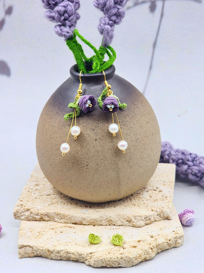Deep purple micro crochet Lily of the Valley blooms cascade elegantly with shimmering 6mm freshwater Aurora pearls. Finished with 18K gold-plated hooks.