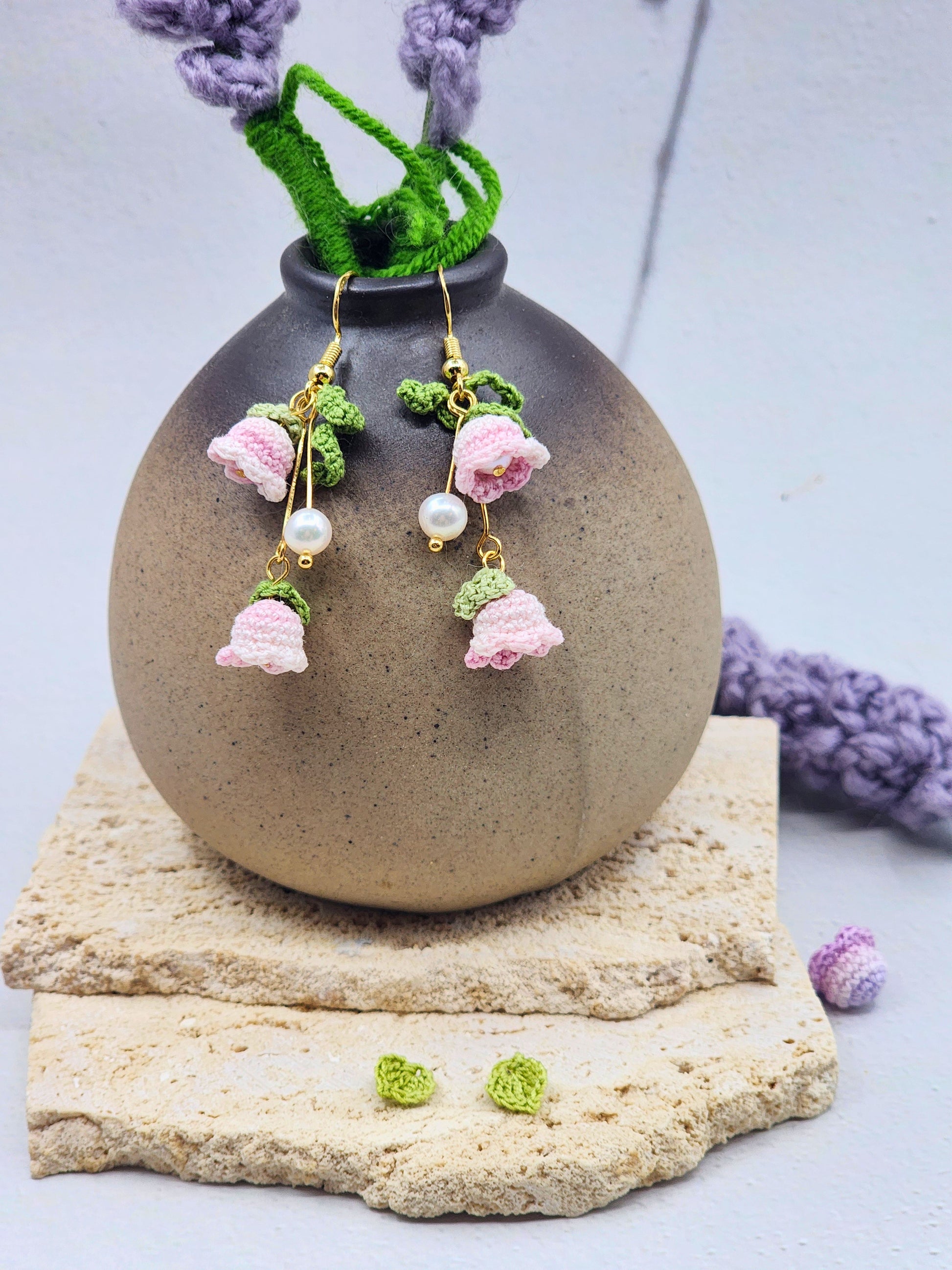 A pair of handcrafted pink micro crochet Lily of the Valley blooms sway delicately with luminous 6mm freshwater Aurora pearls. Finished with gold vermeil hooks.