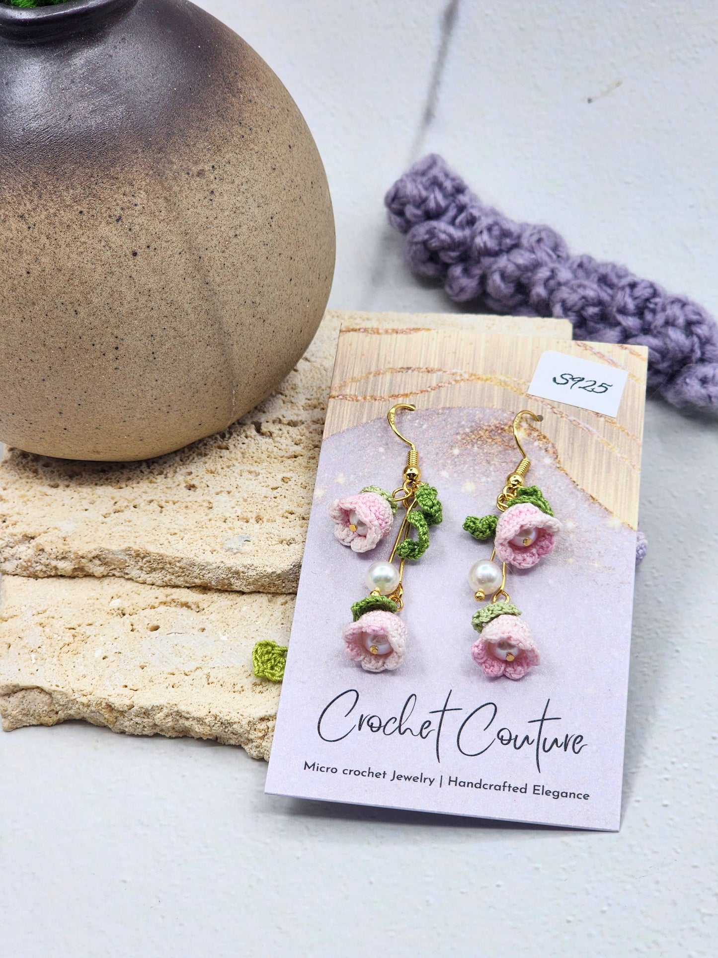 A pair of handcrafted pink micro crochet Lily of the Valley blooms sway delicately with luminous 6mm freshwater Aurora pearls. Finished with gold vermeil hooks.