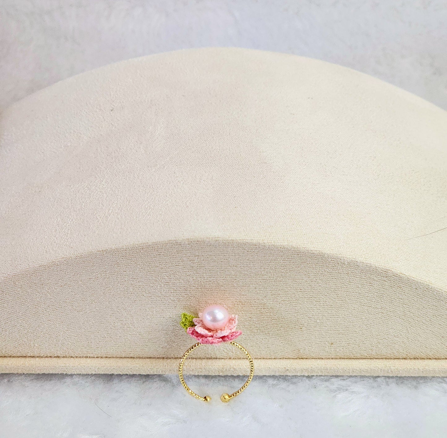 Lustrous pearl ring with pink handcrafted micro-crochet peach blossoms. 14K gold-plated adjustable ring.  
