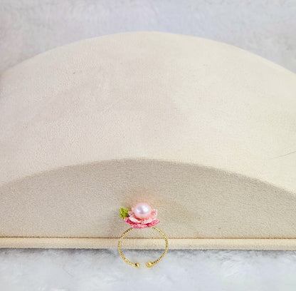 Lustrous pearl ring with pink handcrafted micro-crochet peach blossoms. 14K gold-plated adjustable ring.  