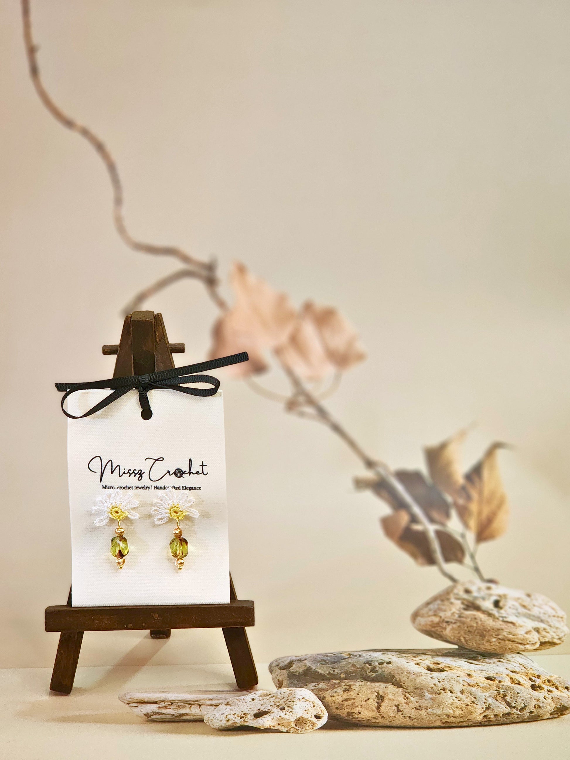 Handcrafted half daisy micro-crochet earrings with green hexagonal Czech glass bead. Styled with 18K gold-plated beads and studs